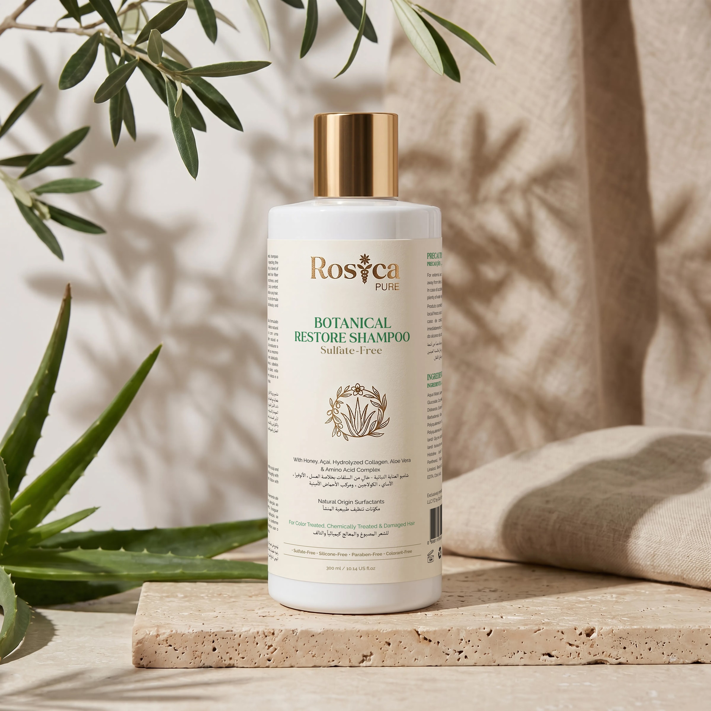 Rosica PURE Botanical Restore Shampoo on travertine with olive branches and aloe vera